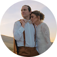 Cassidy and Cory in western wedding attire on an open Montana hillside at dusk